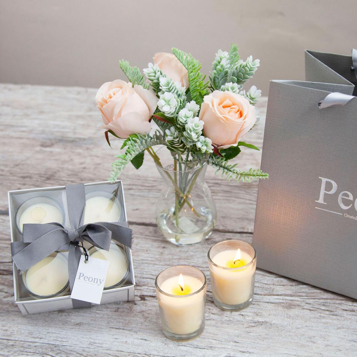 Peach roses winter foliage in a vase with candles gift bag by Peony - Soft peach with greens leaves – image 1