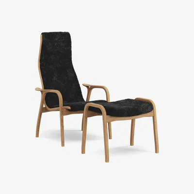 Nordic Nest Swedese Lamino armchair and footstool oiled oak/sheepskin Black