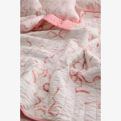 Urban Outfitters Painted Bow Quilted Throw - Pink 127cm x 152cm at Urban Outfitters