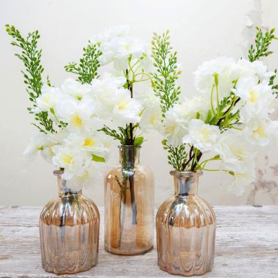 The Range Set of 3 Amber lustre vases with cream blossom stems and foliage by Peony - Soft cream with yellow & green and amber vase
