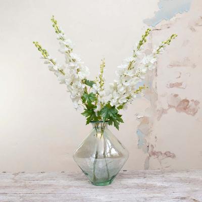 The Range Delphiniums in Decanter Vase by Peony - White and natural with green leaves
